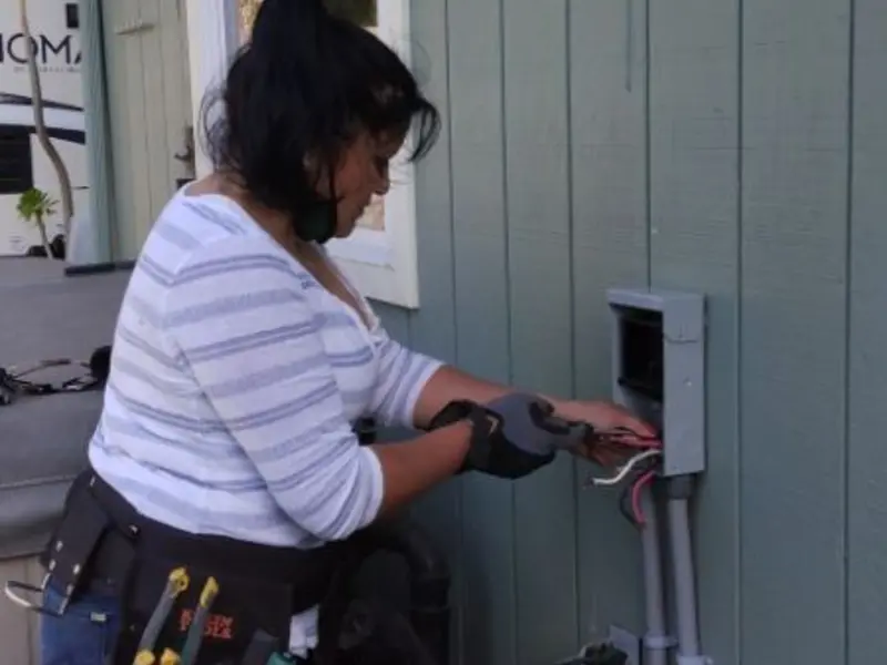Licensed electrician wiring an exterior subpanel in Watertown